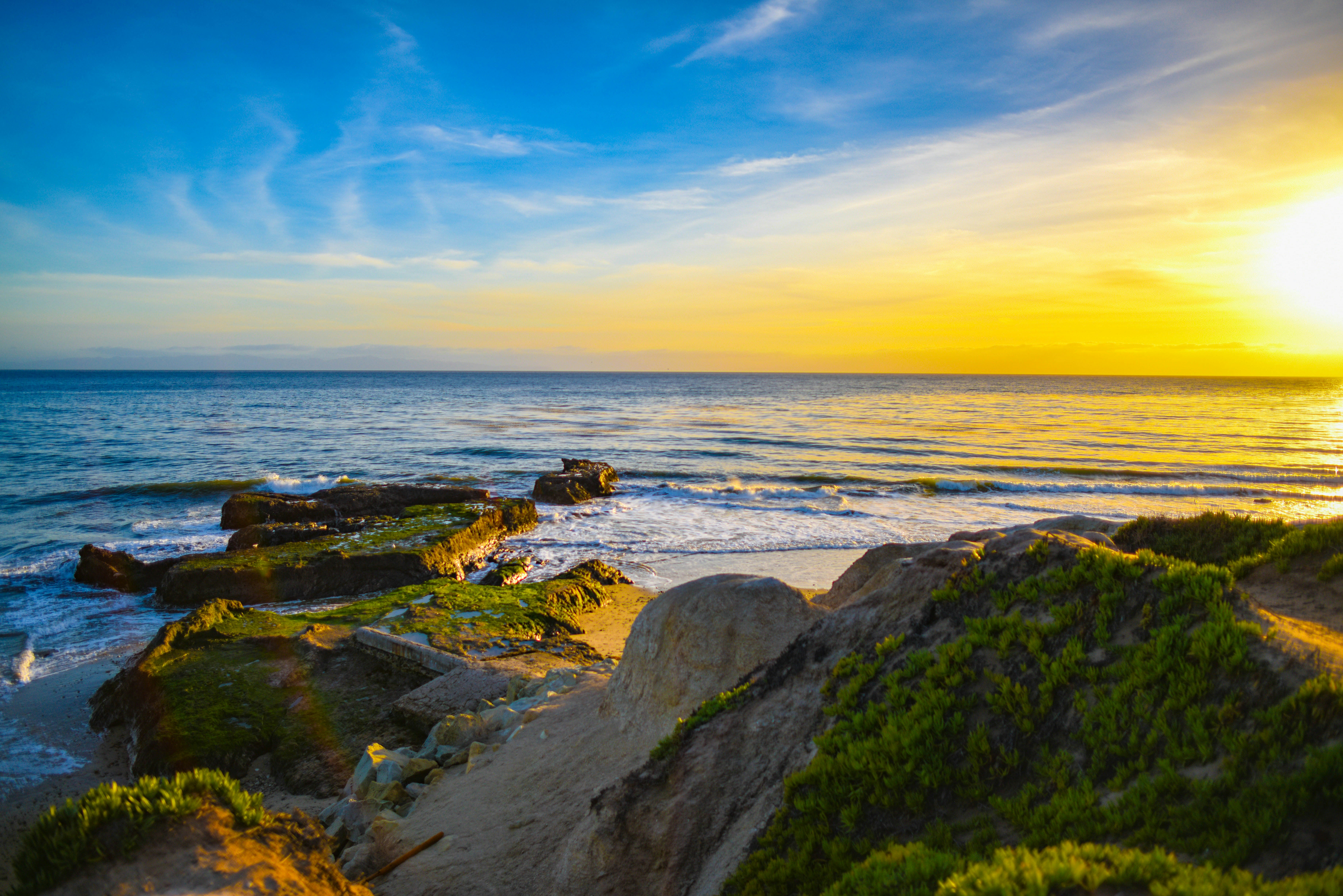rock formation near body of water during daytime, Santa Barbara Sunset