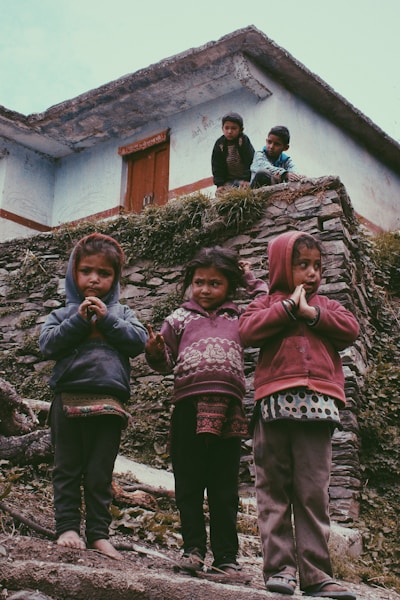 group of children standing near house
