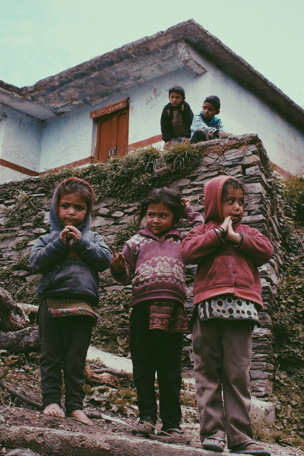 group of children standing near house