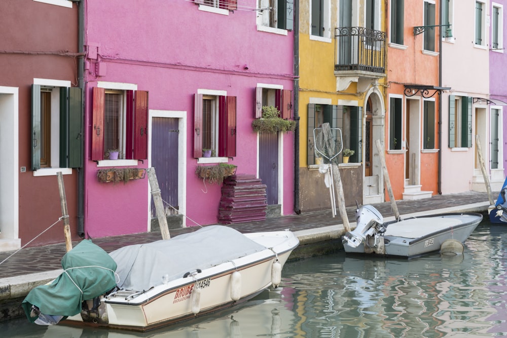 white speedboat parked near house