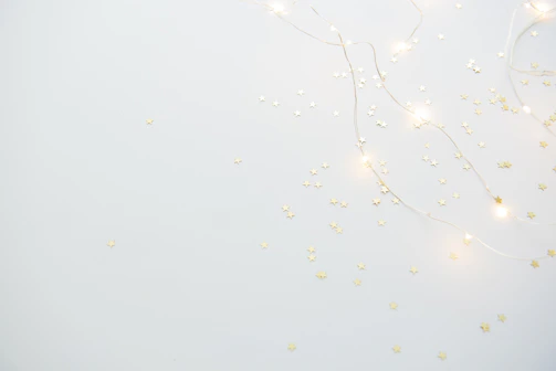 A minimalist starfield with subtle gold sparkles over a deep black background.