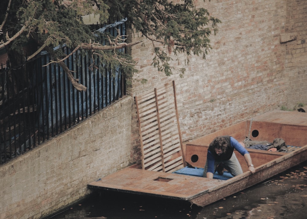 man sitting on jon boat