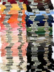 Spools of vibrant embroidery threads neatly arranged by color.