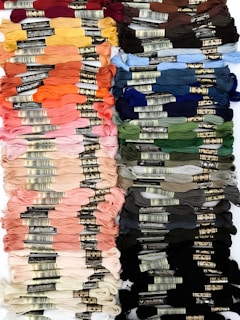 A close-up of colorful textile threads arranged neatly.