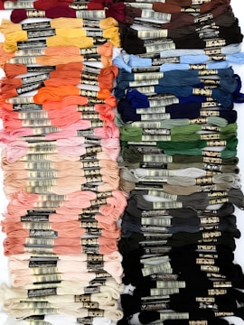 Colorful threads and fabrics arranged neatly on a table.