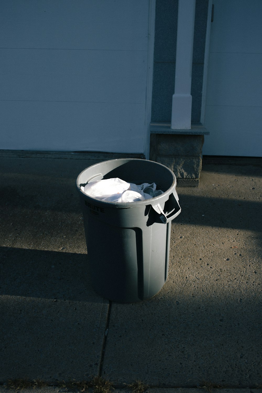 gray plastic trash bin