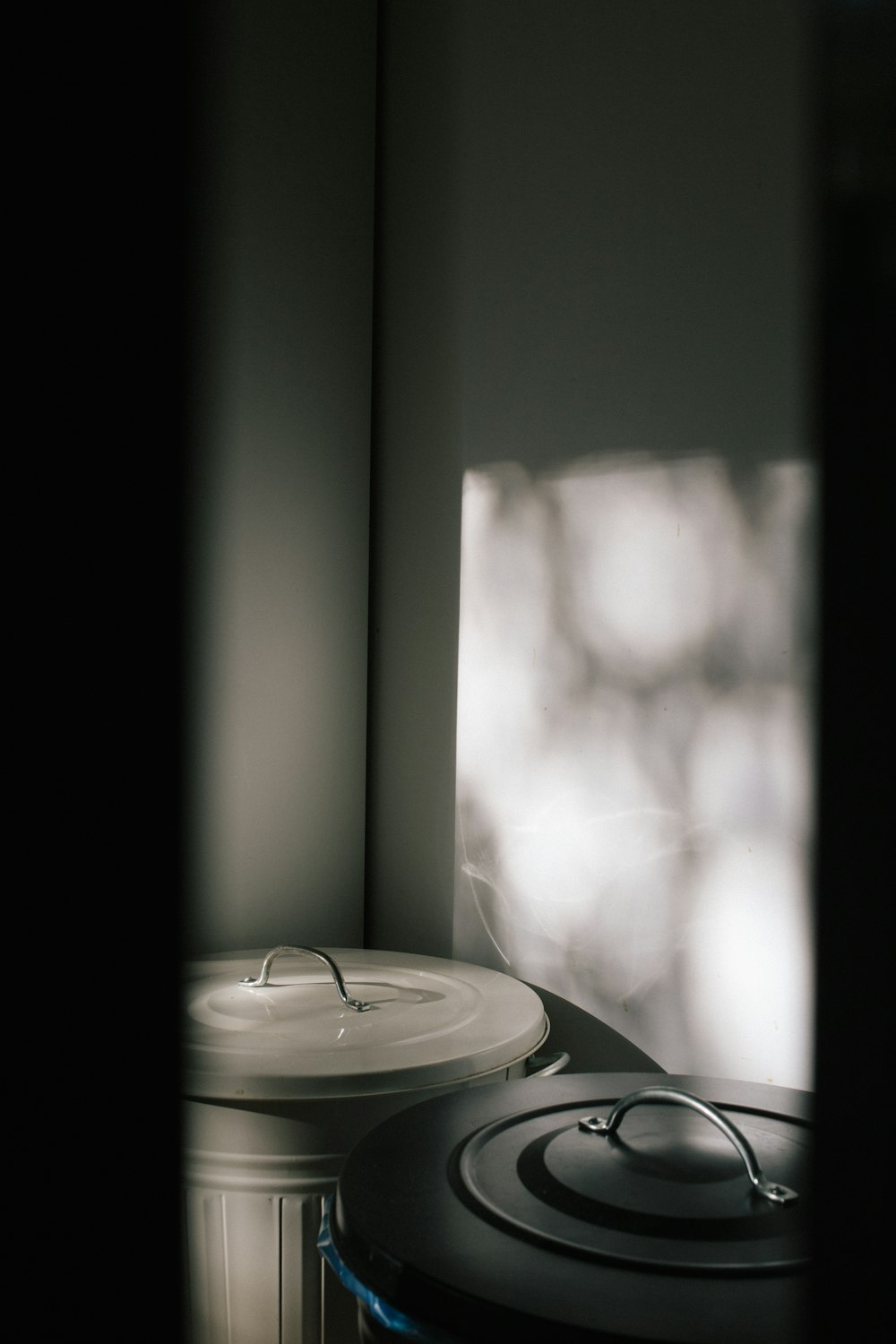 two trash cans inside dark room