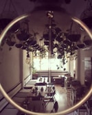 A cozy café interior with wooden tables and plants.
