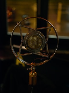 A vintage microphone resting on a wooden table, symbolizing voices seeking truth.
