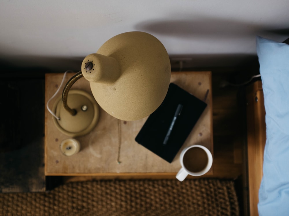 beige gooseneck desk lamp on table