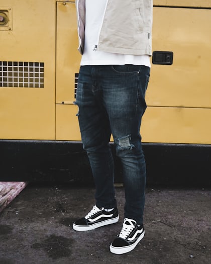 man wearing distressed black denim fitted jeans and pair of black Vans Old  Skool shoes photo – Free Jackandjones Image on Unsplash