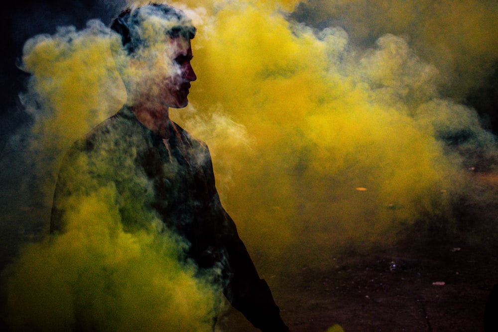man standing surrounded by yellow smoke