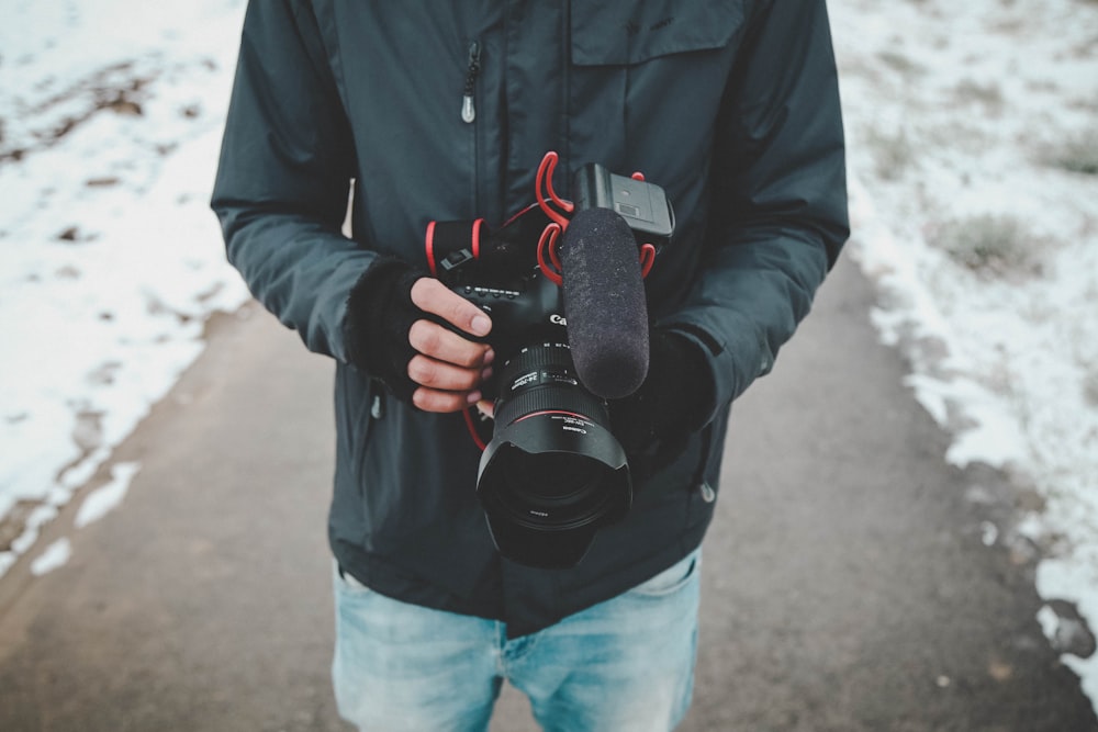 person standing while holding camera