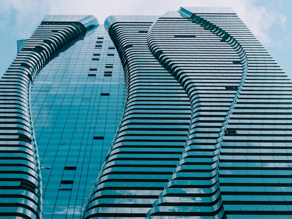 gray concrete tower building under blue and white sky