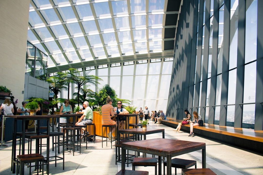 people sitting in front of bar table, People in the Sky Garden