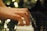Hands gracefully play the keys of a piano with blurred bokeh lights creating a soft, serene background.