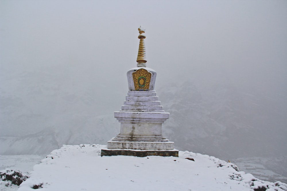 gray concrete statue on snow land