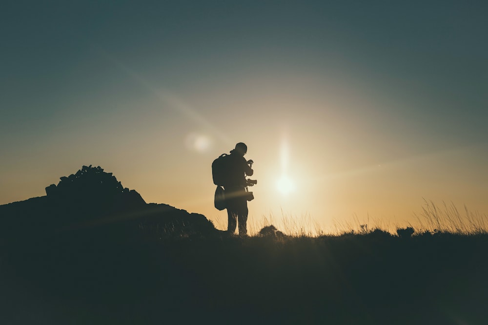 silhouette of mountain climber at golden hour