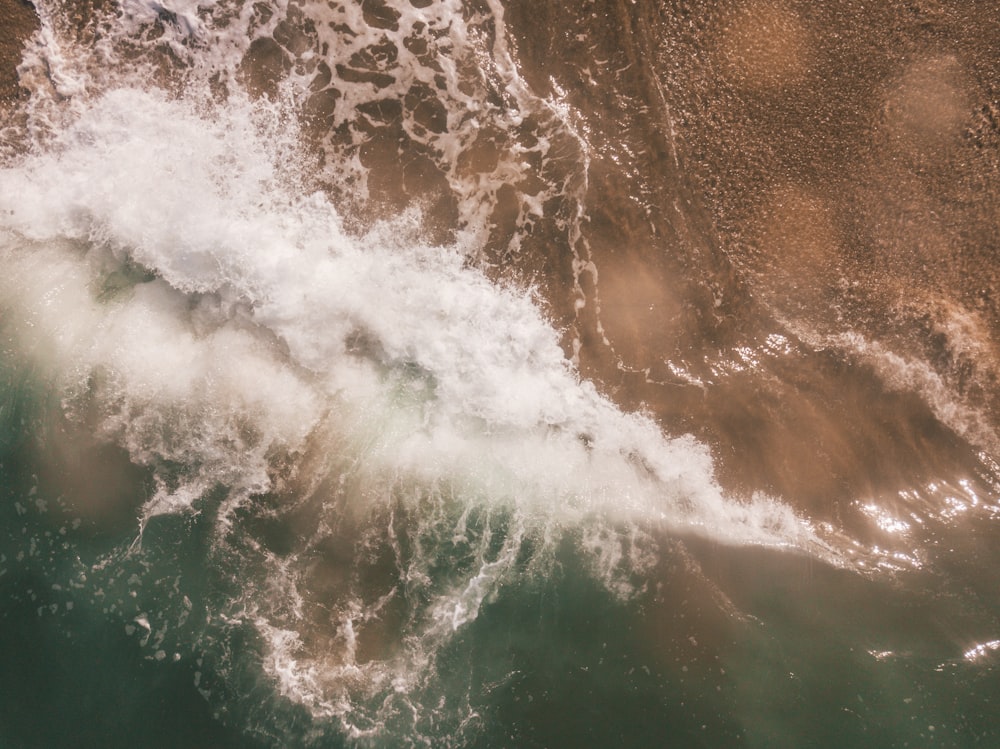 sea waves splashing near seashore at daytime