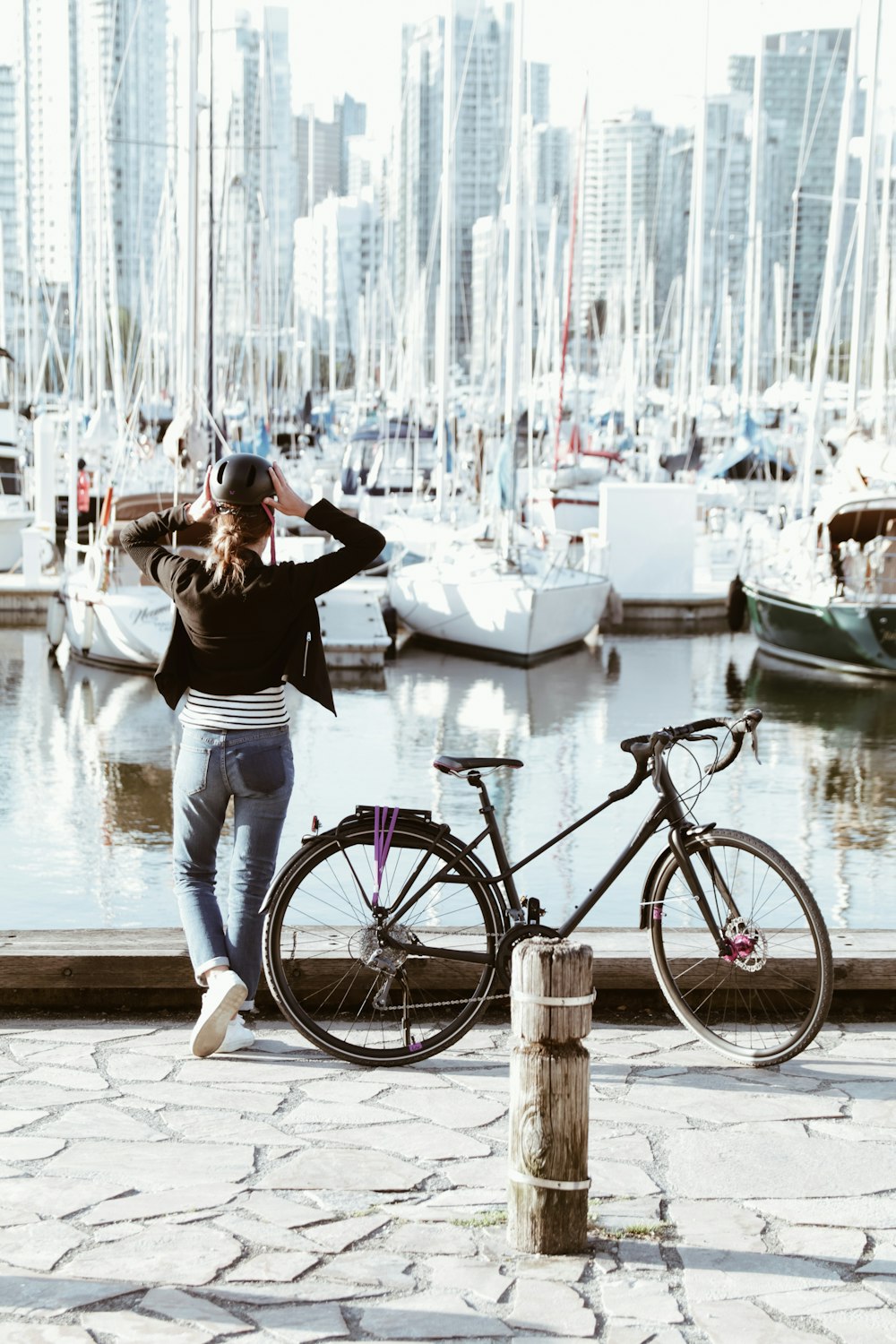 person standing beside road bicycle during daytime