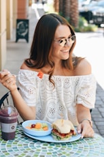 woman eating fruits and sandwich