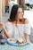 woman eating fruits and sandwich