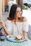 woman eating fruits and sandwich