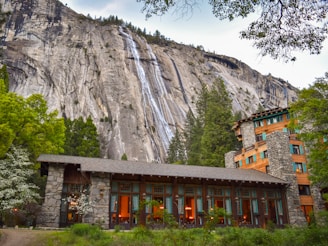 building in the foot of the mountain near trees