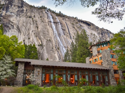 building in the foot of the mountain near trees