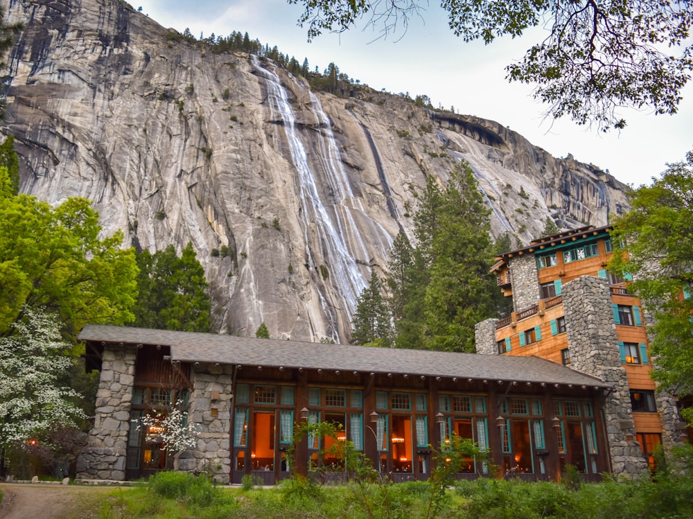 building in the foot of the mountain near trees