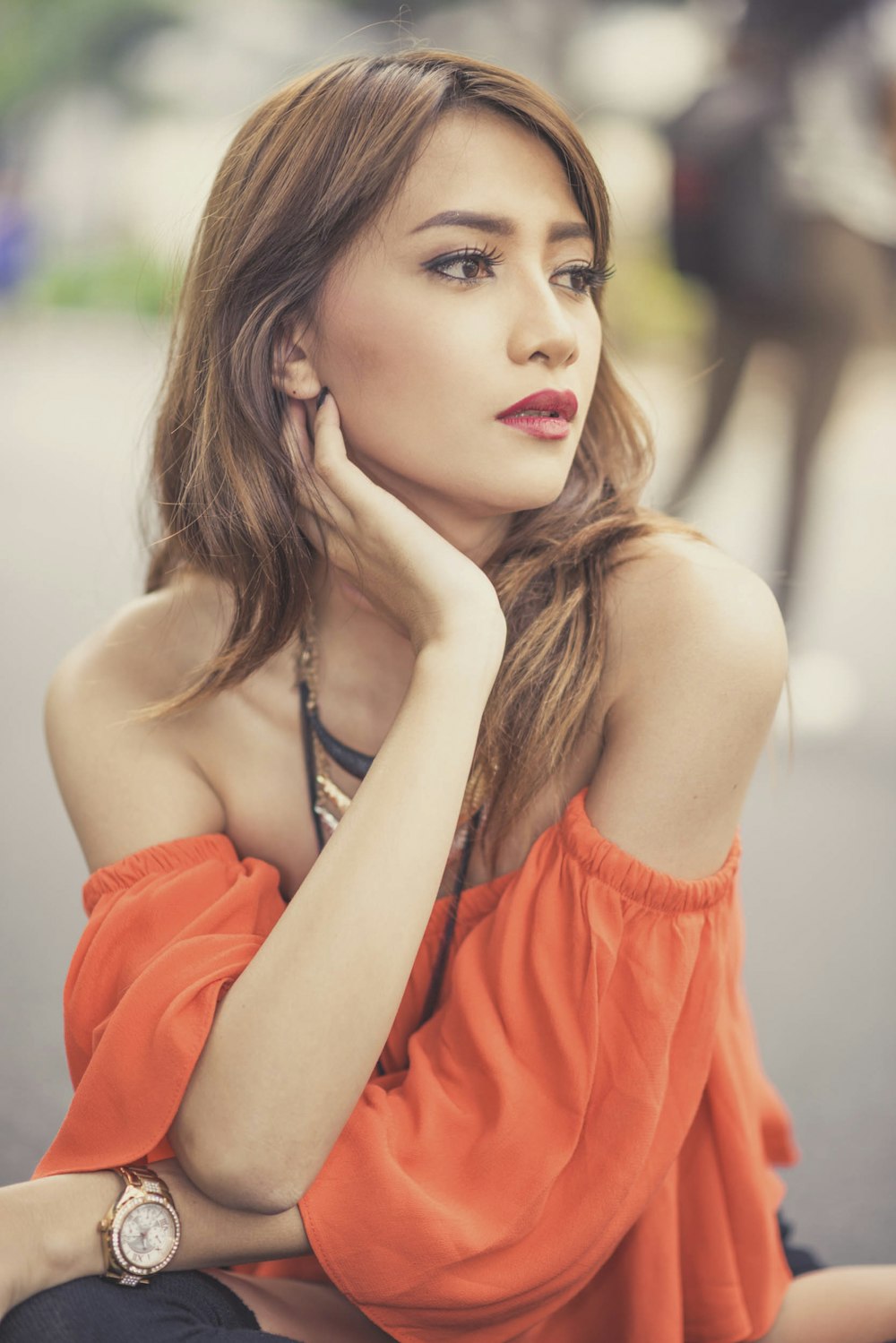 shallow focus photo of woman holding her neck