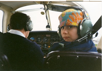 Children wearing flight goggles and headphones, excitedly preparing for their first solo drone flight.