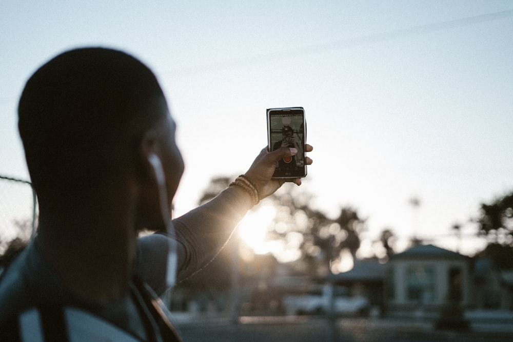 a man taking a picture with his cell phone