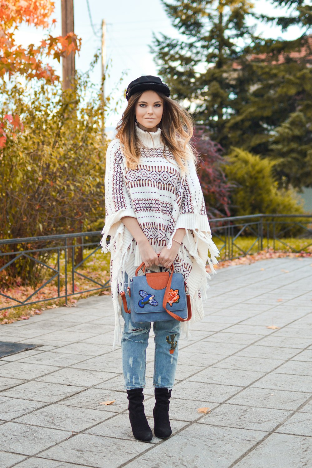 woman holding blue and brown 2-way bag