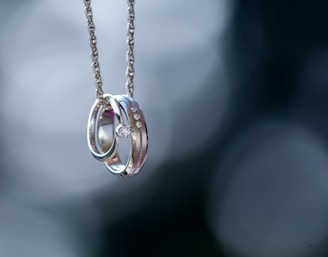 silver-colored ring pendant