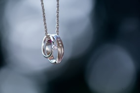 silver-colored ring pendant