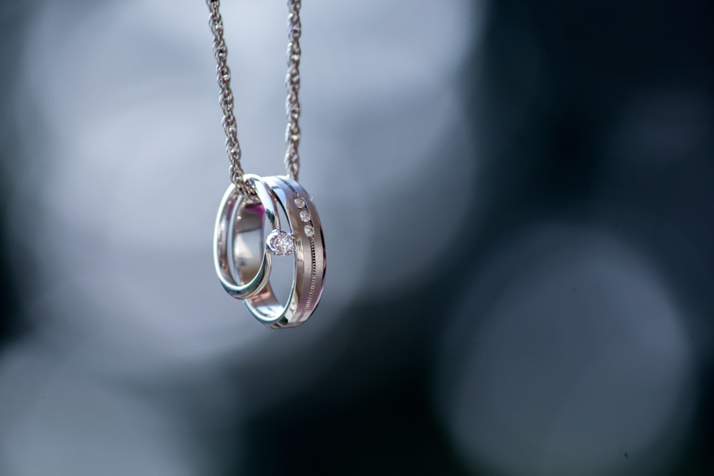 silver-colored ring pendant