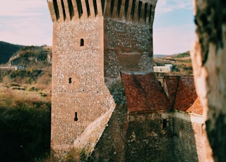 brown concrete castle on the edge of cliff