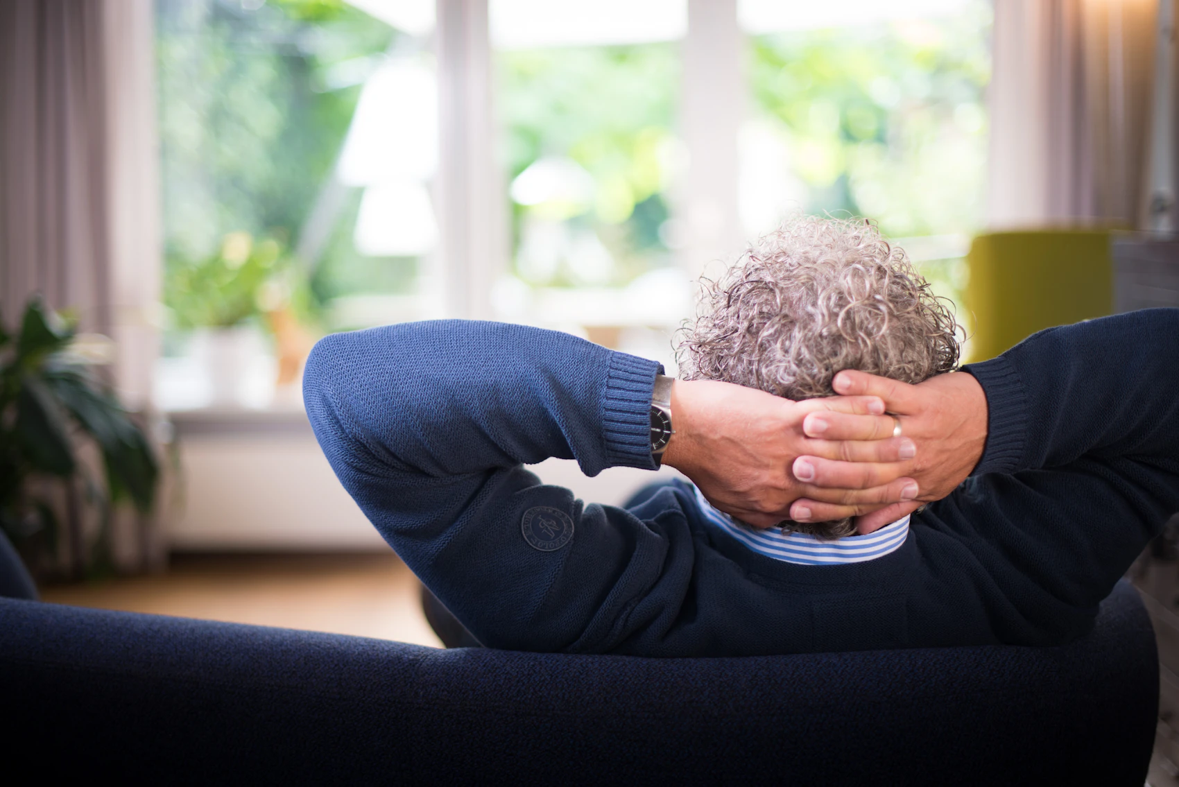 Man resting while lying on a sofa at home