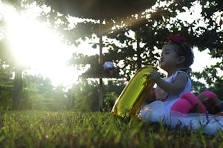A cheerful child holding a honeycomb-shaped balloon outside blittlebees childcare.