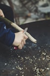 man carving stick