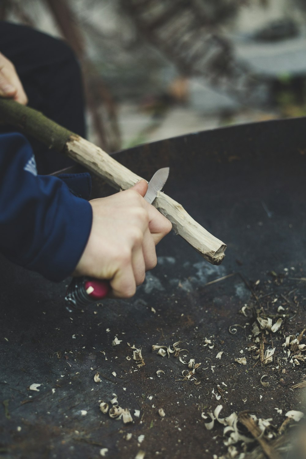 man carving stick