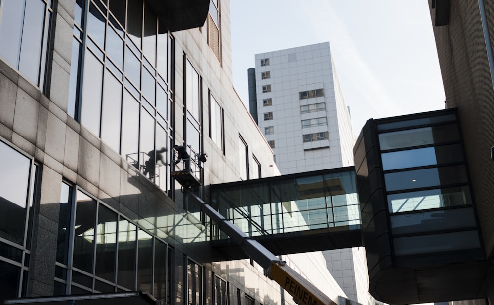 building window cleaner on building wall during daytime