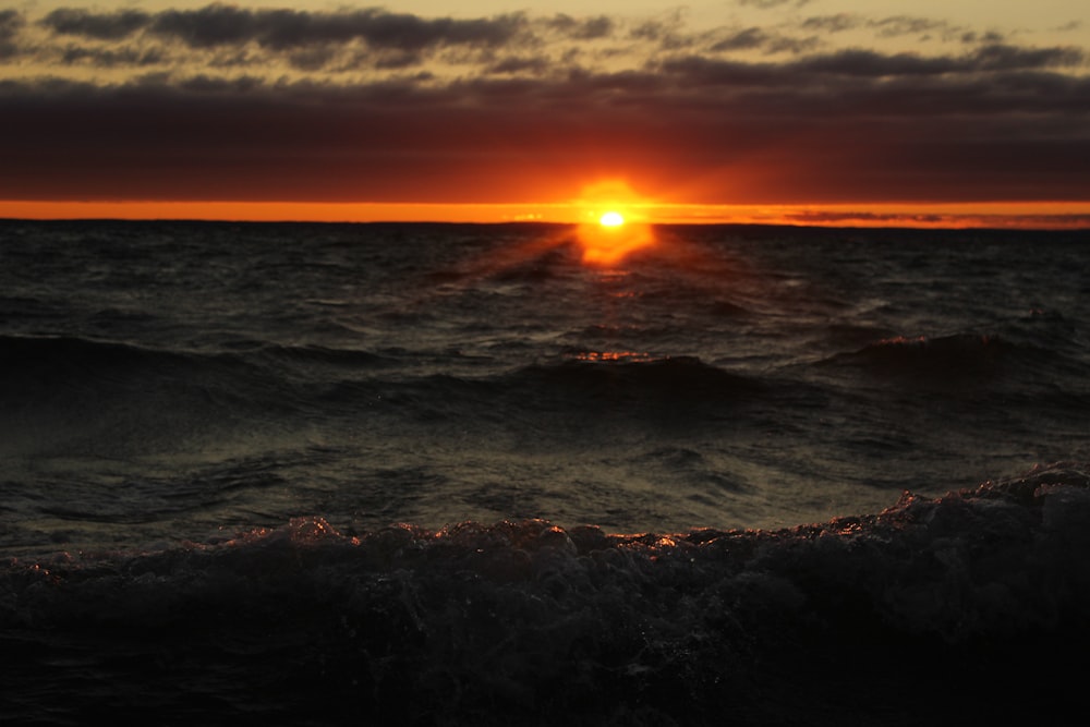 time lapse photography of sea waves under golden hour