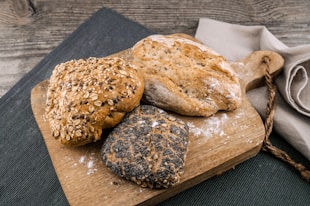 three toasted bread on brown chopping board