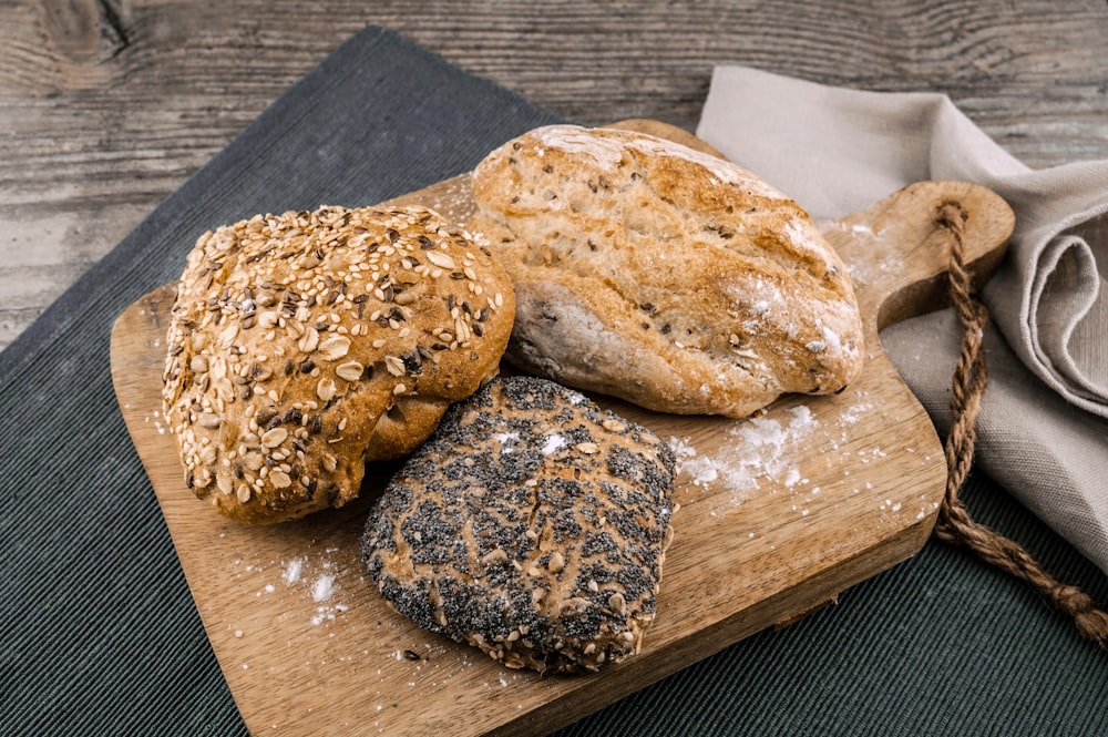 three toasted bread on brown chopping board