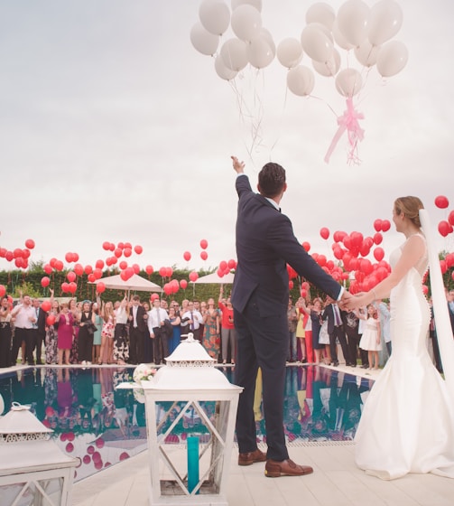 photo of a man and woman newly wedding holding a balloons