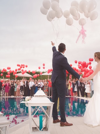 photo of a man and woman newly wedding holding a balloons