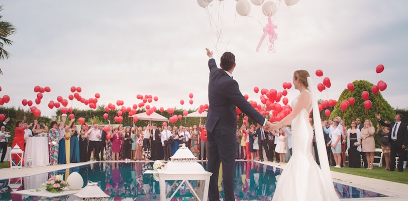 photo of a man and woman newly wedding holding a balloons