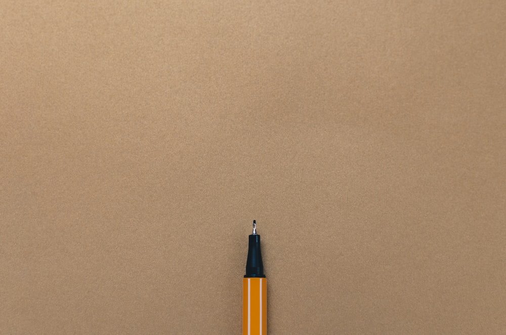 pen on brown board